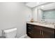 Contemporary bathroom with granite countertop, dark cabinets and tub and shower in the mirror at 910 Pebble Creek Trl, Suwanee, GA 30024