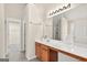 Bathroom vanity with a long mirror, wood cabinets, and ample space with easy access to storage at 910 Pebble Creek Trl, Suwanee, GA 30024