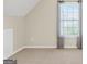 Cozy bedroom with neutral carpet and walls featuring a window and white molding at 910 Pebble Creek Trl, Suwanee, GA 30024