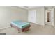 Bedroom with neutral walls and carpet featuring a bed and access to storage and other rooms at 910 Pebble Creek Trl, Suwanee, GA 30024