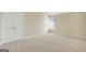 Bedroom featuring double doors, carpeted floors, neutral walls, and a window at 910 Pebble Creek Trl, Suwanee, GA 30024