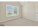 Bedroom featuring neutral walls and carpet with a large window providing natural light at 910 Pebble Creek Trl, Suwanee, GA 30024