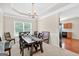 Formal dining room with tray ceiling, chandelier, and a large table with comfortable seating for gatherings at 910 Pebble Creek Trl, Suwanee, GA 30024