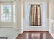 Bright foyer featuring hardwood floors, decorative molding, and a glimpse into the adjacent living spaces at 910 Pebble Creek Trl, Suwanee, GA 30024