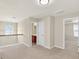 Open hallway with a window featuring decorative molding and an entry to a bathroom and bedroom at 910 Pebble Creek Trl, Suwanee, GA 30024