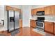 Bright kitchen featuring stainless steel appliances, wood cabinetry, and a convenient layout for cooking at 910 Pebble Creek Trl, Suwanee, GA 30024