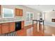 Kitchen with wooden cabinets, stainless steel dishwasher, eat in bar, and lots of natural light at 910 Pebble Creek Trl, Suwanee, GA 30024