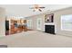 Open-concept living area with fireplace, leading into the kitchen, featuring neutral tones and ample space at 910 Pebble Creek Trl, Suwanee, GA 30024