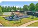 Community playground featuring a variety of play structures, including slides, climbing equipment, and a basketball court at 910 Pebble Creek Trl, Suwanee, GA 30024