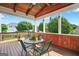 Covered back porch features wood floors, wood accents, and neighborhood views at 910 Pebble Creek Trl, Suwanee, GA 30024
