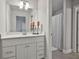 This bright bathroom features a white vanity, mirror, decor and a shower with curtain at 33 Vinery Ct, Sharpsburg, GA 30277