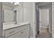 This bright bathroom features a white vanity, large mirror, and a view into the tiled shower at 33 Vinery Ct, Sharpsburg, GA 30277