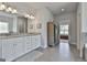 This primary bathroom has granite countertops, double sinks, and natural light at 33 Vinery Ct, Sharpsburg, GA 30277