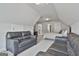 Spacious bedroom features two gray sofas, carpet and neutral decor with comfortable furnishings at 33 Vinery Ct, Sharpsburg, GA 30277