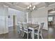 Dining area with wainscotting, hardwood floors, coffered ceiling and elegant lighting at 33 Vinery Ct, Sharpsburg, GA 30277