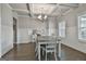 Elegant dining room featuring coffered ceilings and hardwood floors, bathed in natural light at 33 Vinery Ct, Sharpsburg, GA 30277