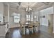 Bright dining area with wainscotting, hardwood floors, and many windows allowing natural light at 33 Vinery Ct, Sharpsburg, GA 30277