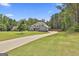 Expansive home situated on a large lot with mature trees and a long driveway, providing privacy and curb appeal at 33 Vinery Ct, Sharpsburg, GA 30277