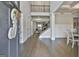 Grand foyer with hardwood floors, soaring ceilings, staircase, and natural light, offering a stunning first impression at 33 Vinery Ct, Sharpsburg, GA 30277