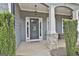 Close-up of the front door, showcasing elegant details, sidelights, and a stone-accented column at 33 Vinery Ct, Sharpsburg, GA 30277