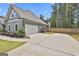 Spacious two-car garage with a concrete driveway and well-kept landscaping at 33 Vinery Ct, Sharpsburg, GA 30277