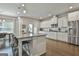 Gourmet kitchen featuring an island with bar seating and modern stainless steel appliances at 33 Vinery Ct, Sharpsburg, GA 30277