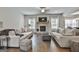 Comfortable living room with a stone fireplace, hardwood floors, and lots of seating at 33 Vinery Ct, Sharpsburg, GA 30277