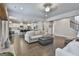 Bright open-concept living room flows into kitchen featuring hardwood floors and neutral color palette at 33 Vinery Ct, Sharpsburg, GA 30277