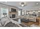Open-concept living room with stone fireplace and hardwood floors, flowing into the kitchen at 33 Vinery Ct, Sharpsburg, GA 30277