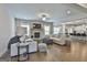 Open living room featuring a stone fireplace, hardwood floors, and access to the kitchen at 33 Vinery Ct, Sharpsburg, GA 30277