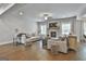 Bright and airy living room with hardwood floors and a stone fireplace, perfect for relaxation at 33 Vinery Ct, Sharpsburg, GA 30277