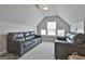 Upper level room with leather couches, natural light, and carpet flooring at 33 Vinery Ct, Sharpsburg, GA 30277