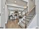 Spacious living room with stone fireplace, hardwood floors, and staircase at 33 Vinery Ct, Sharpsburg, GA 30277