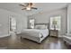 This spacious main bedroom features hardwood floors, a ceiling fan, and great natural light at 33 Vinery Ct, Sharpsburg, GA 30277