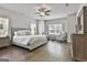 Spacious primary bedroom with hardwood floors, a ceiling fan, and a seating area at 33 Vinery Ct, Sharpsburg, GA 30277