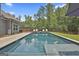 Backyard pool features lounge chairs, green grass, and lush trees for a private outdoor retreat at 33 Vinery Ct, Sharpsburg, GA 30277