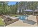 Relaxing poolside scene with lounge chairs and umbrellas overlooking the sparkling pool, surrounded by a green lawn at 33 Vinery Ct, Sharpsburg, GA 30277