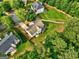 Aerial view of a home with a well-kept lawn, set amidst a mix of houses and greenery at 1132 Hargrove Ct, Locust Grove, GA 30248