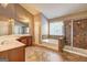Spacious bathroom featuring double vanity, jetted tub, and separate glass shower at 1132 Hargrove Ct, Locust Grove, GA 30248