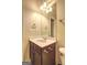 Standard bathroom with a single sink vanity, large mirror and neutral color palette at 1132 Hargrove Ct, Locust Grove, GA 30248
