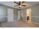 Bedroom with carpet and ceiling fan. Features doorway to bathroom at 1132 Hargrove Ct, Locust Grove, GA 30248