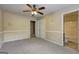 Bedroom with carpet, ceiling fan, and view to attached bathroom at 1132 Hargrove Ct, Locust Grove, GA 30248