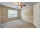 Bedroom with large window, ceiling fan, neutral carpet, and fresh paint potential at 1132 Hargrove Ct, Locust Grove, GA 30248