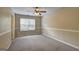 Neutral bedroom with carpet, ceiling fan, and large window providing natural light at 1132 Hargrove Ct, Locust Grove, GA 30248