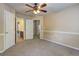 View of bedroom with neutral carpet, ceiling fan, and door to the bathroom at 1132 Hargrove Ct, Locust Grove, GA 30248