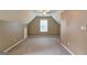 Bonus room featuring carpeted floor, ceiling fan, and a large window at 1132 Hargrove Ct, Locust Grove, GA 30248