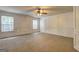 Large bonus room with paneled walls, carpet and two windows at 1132 Hargrove Ct, Locust Grove, GA 30248