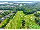 Beautiful aerial view of the golf course, showcasing its well-manicured fairways and bunkers with homes nearby at 1132 Hargrove Ct, Locust Grove, GA 30248