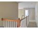 Hallway with neutral walls, white trim, and carpeted flooring on the second level at 1132 Hargrove Ct, Locust Grove, GA 30248