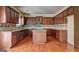 Spacious kitchen with wood cabinets, a center island, granite countertops, and hardwood floors at 1132 Hargrove Ct, Locust Grove, GA 30248